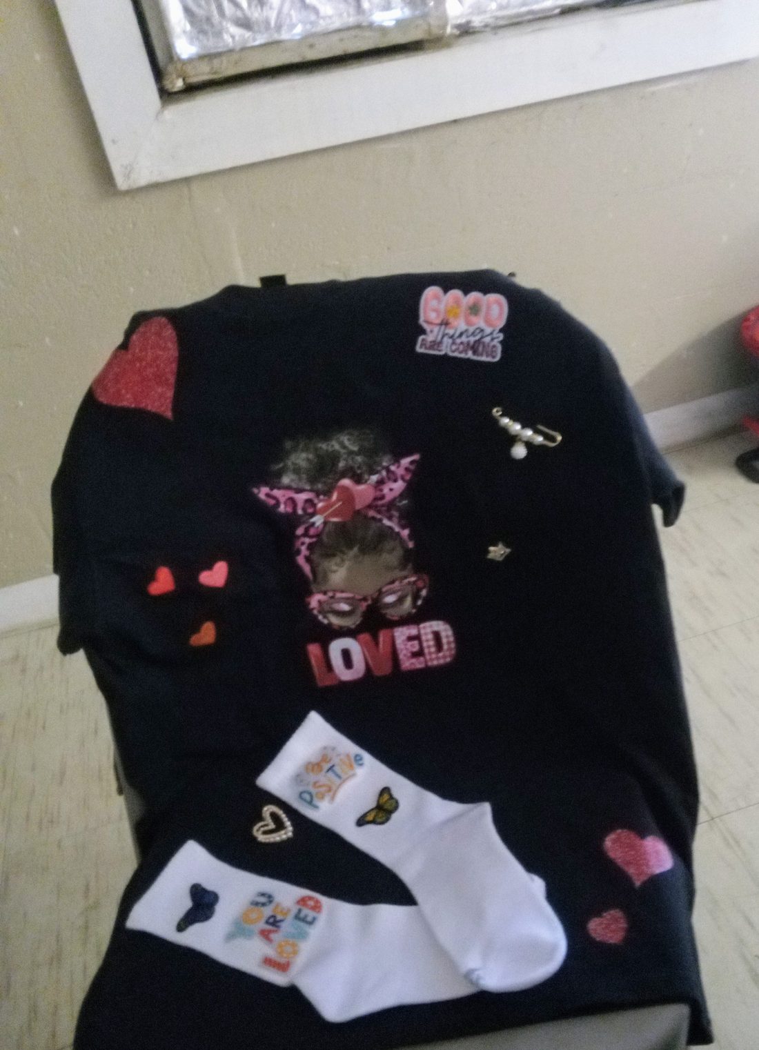 Custom black LOVED t-shirt with heart patches and pins, with matching You Are Loved socks
